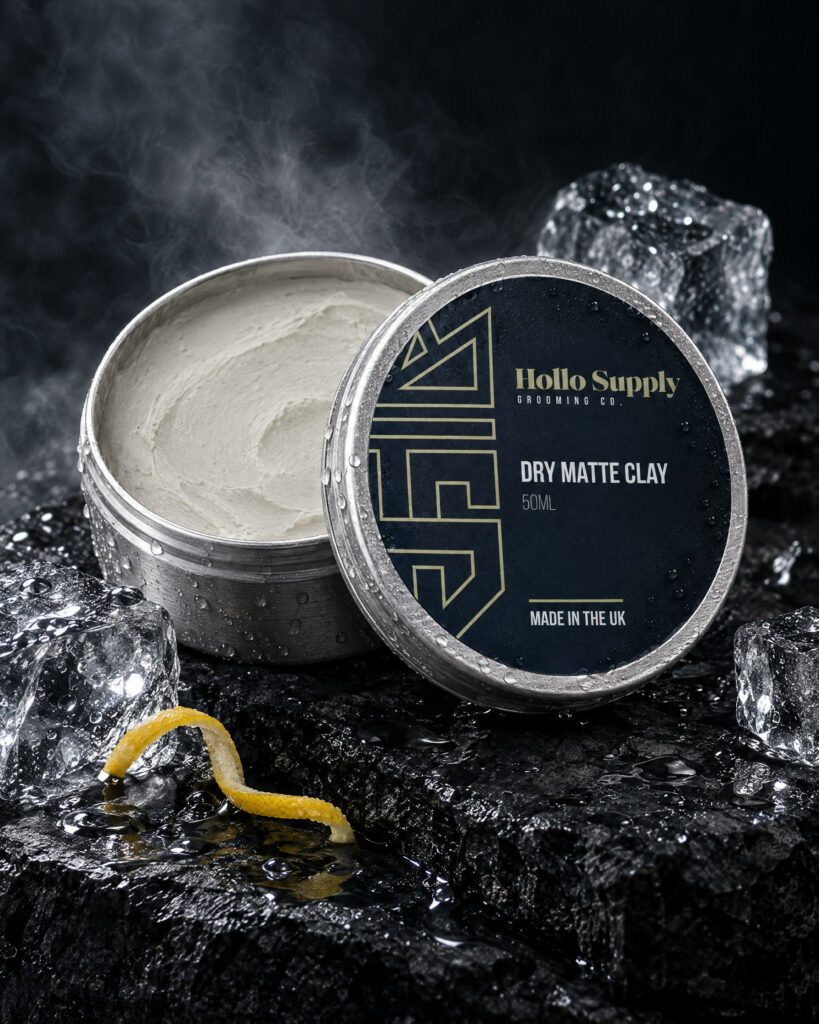 Dry Matte Clay (50ml) by Hollo Supply Grooming Co., photographed on wet charcoal stone with water