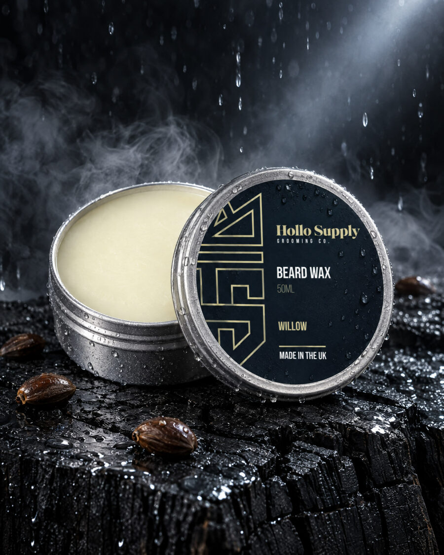 Beard Wax (Willow) by Hollo Supply Grooming Co., photographed on wet charcoal stone with water