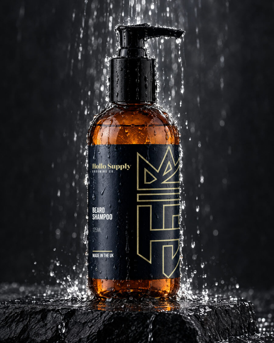 Beard Shampoo by Hollo Supply Grooming Co., photographed on wet charcoal stone with water