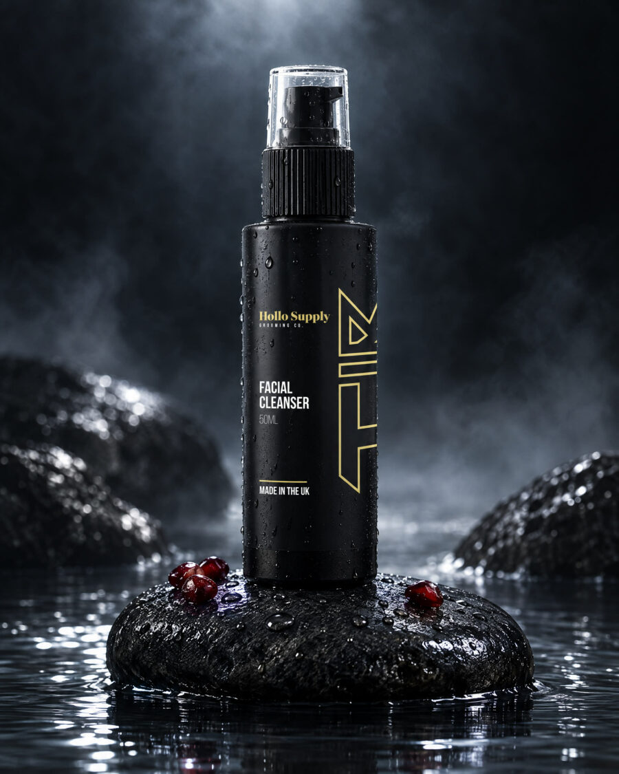 Facial Cleanser by Hollo Supply Grooming Co., photographed on wet charcoal stone with water