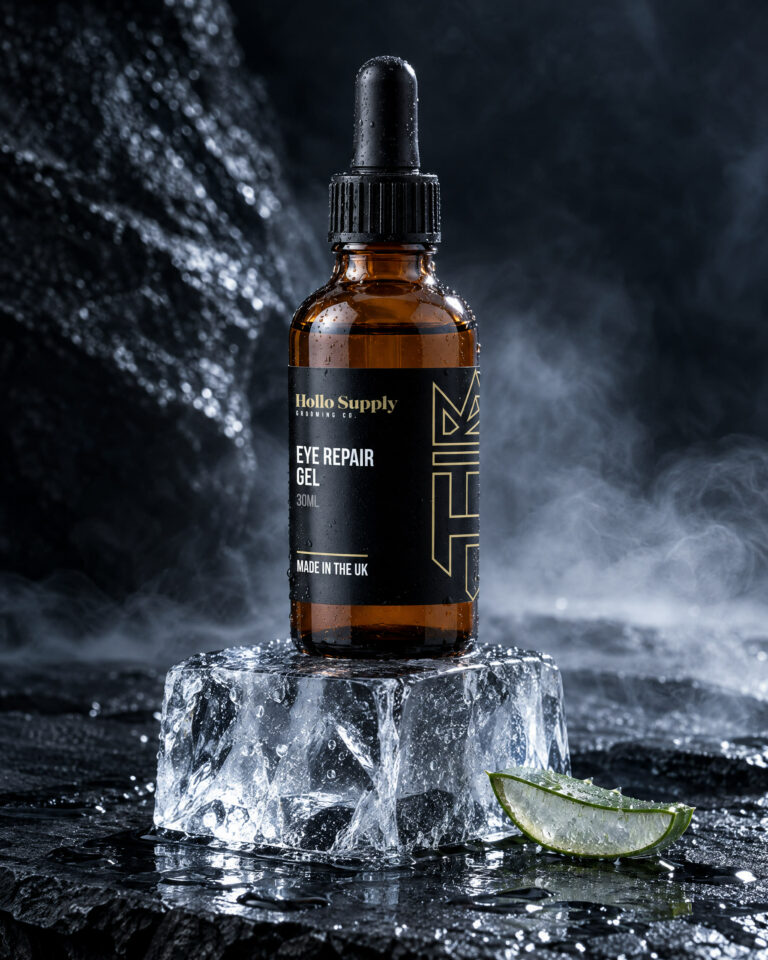 Elixir Eye Repair Gel by Hollo Supply Grooming Co., photographed on wet charcoal stone with water